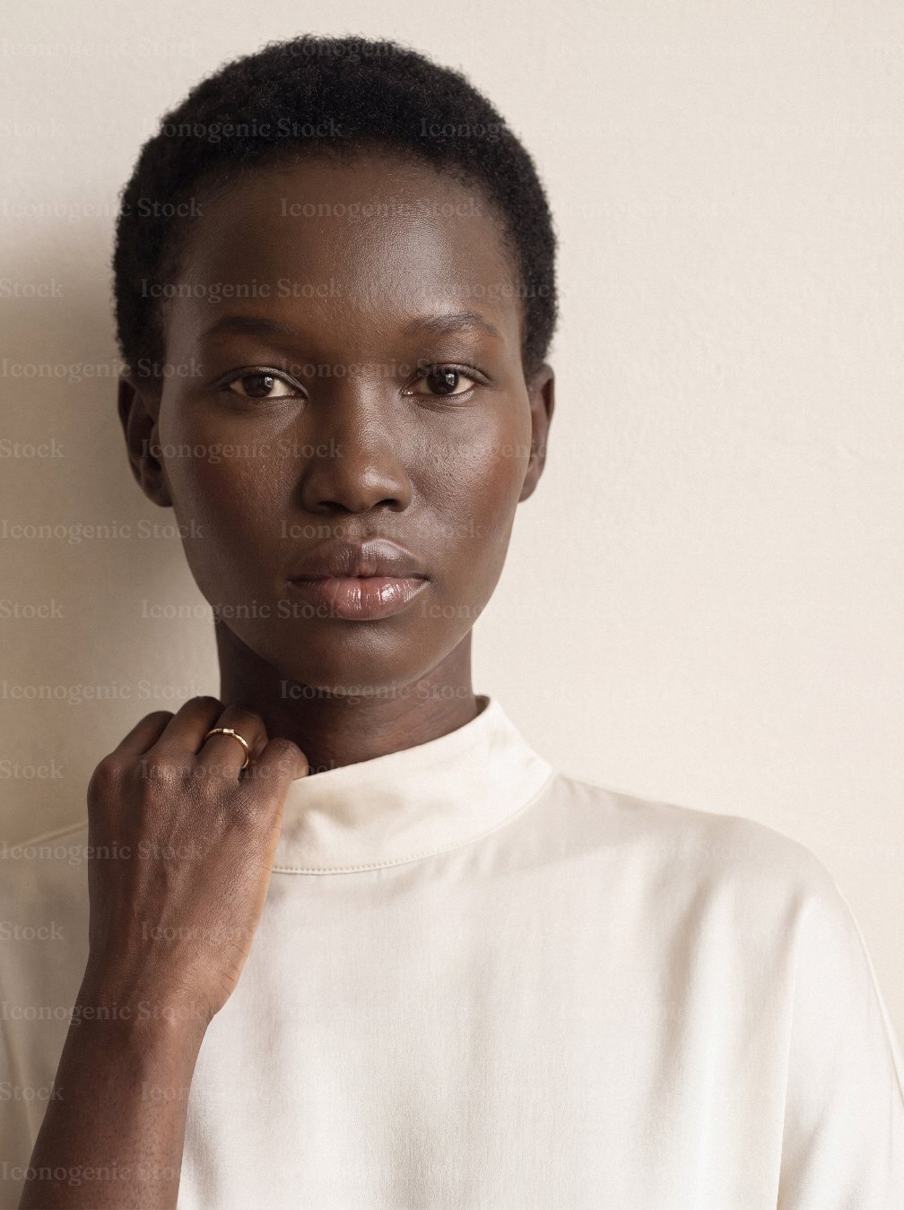 Portrait of confident African woman with short natural hair in cream blouse