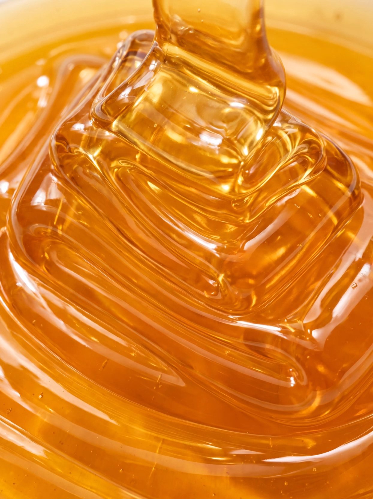 Golden Honey Pouring and Swirling in Close-Up Macro View