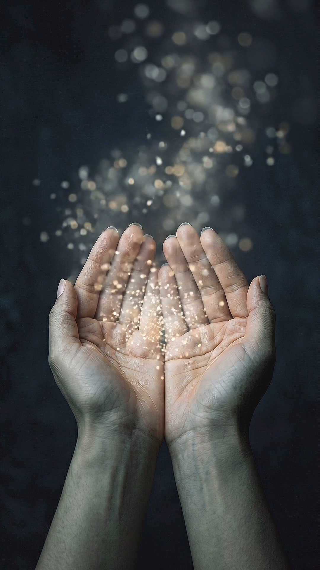 Cupped hands holding glowing golden magic sparkles against dark background